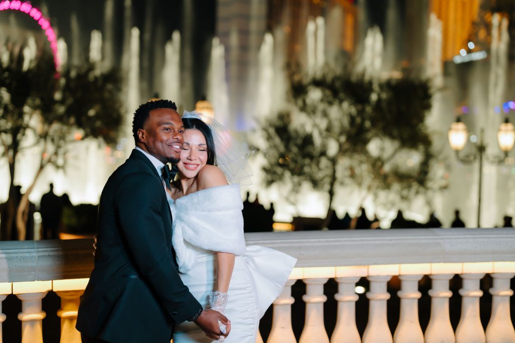 Las Vegas Strip elopement couple embracing at Bellagio Fountains at night with romantic atmosphere, photographed by Zoltan Redl-Nagy