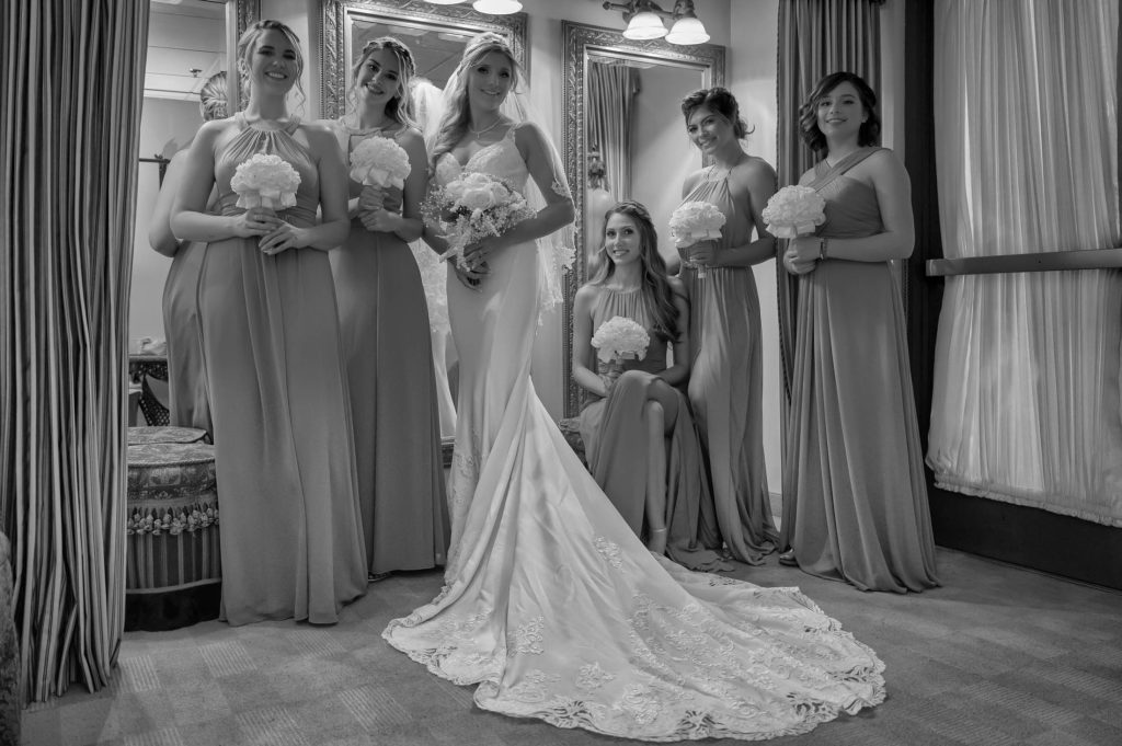 Bride with bridesmaids bridal party portrait indoors black and white