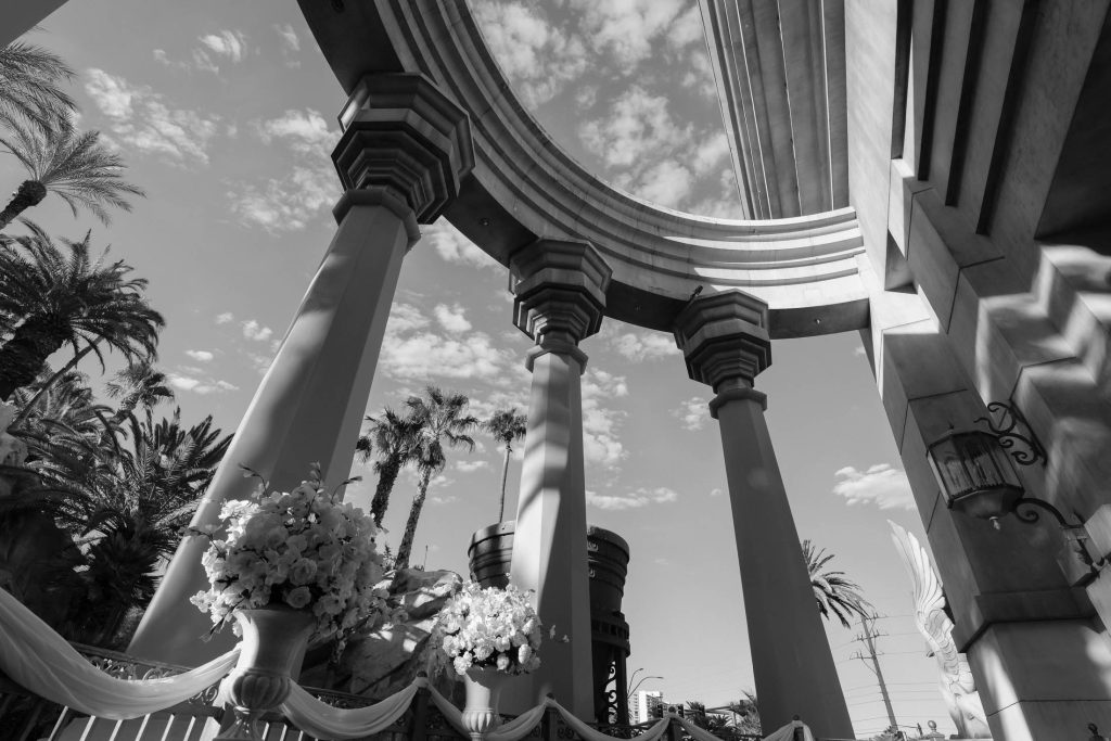 Mandalay Bay Valley of the Falls wedding ceremony location columns and floral decor black and white