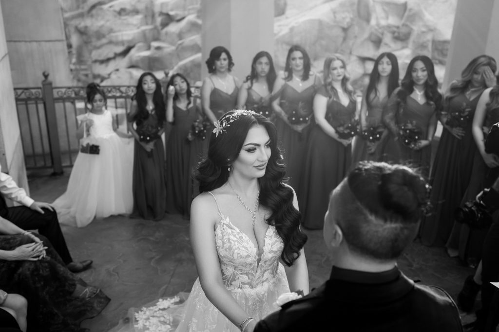 Bride and groom exchanging vows at Mandalay Bay Valley of the Falls ceremony black and white