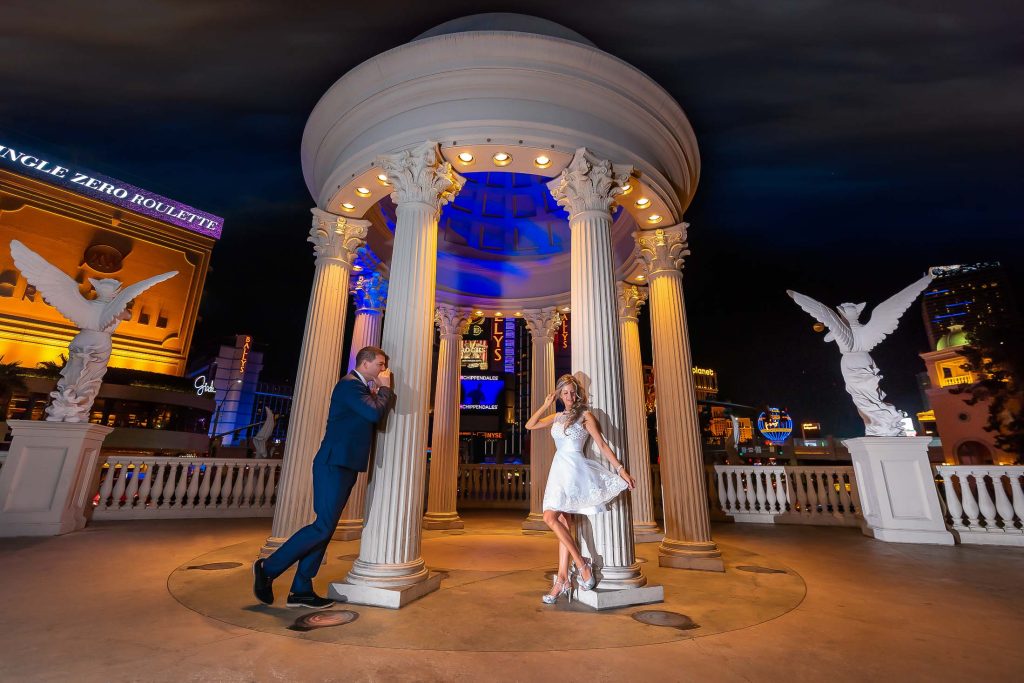 Las Vegas Strip elopement couple at Caesars Palace gazebo at night with dramatic lighting and iconic architecture, photographed by Zoltan Redl-Nagy