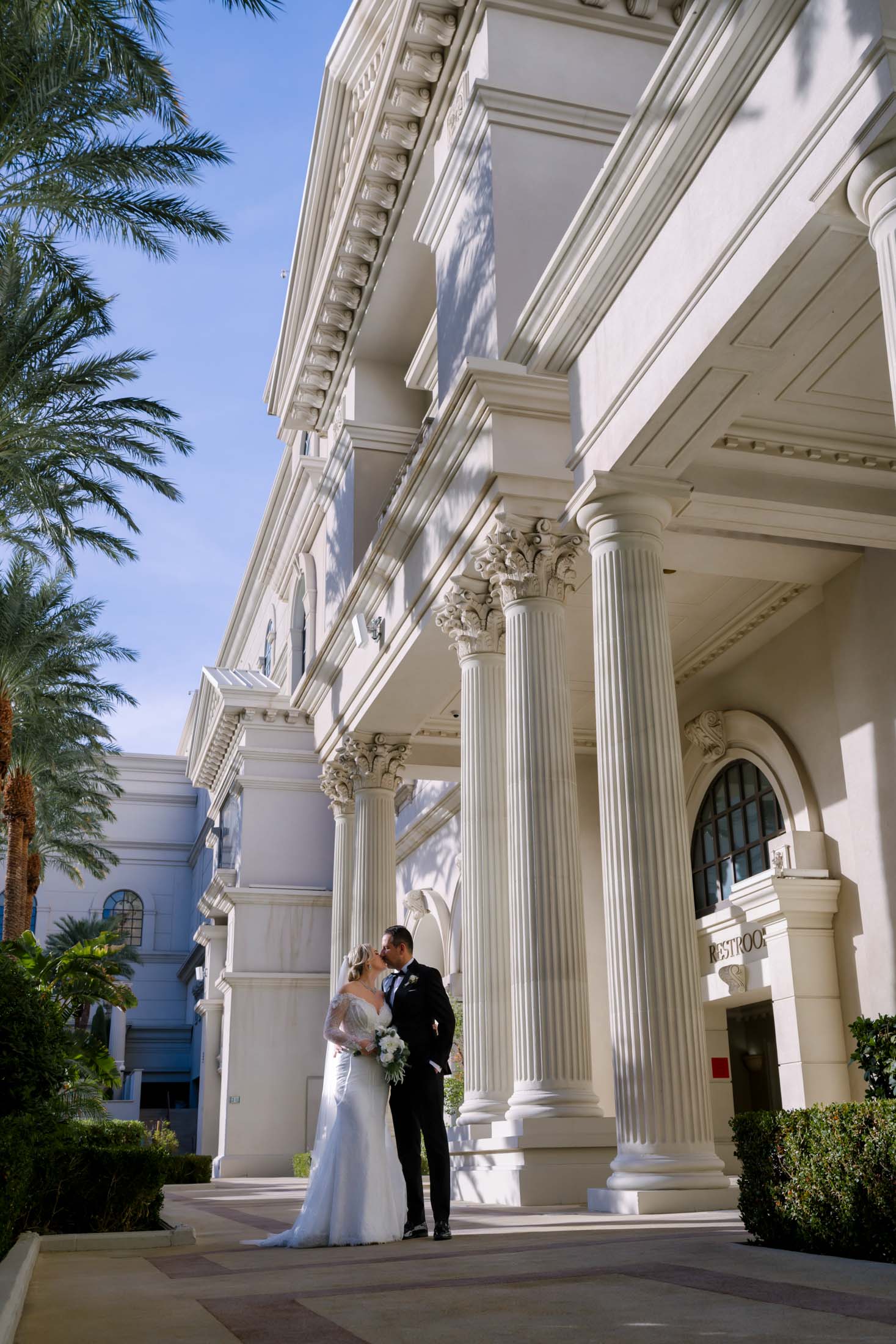 bride and groom portrait by columns at Caesars Palace Las Vegas wedding photographed by Zoltan Redl Nagy