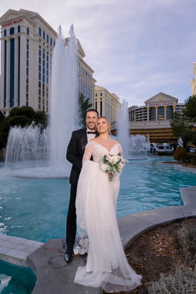bride and groom portrait by fountain Caesars Palace Las Vegas wedding photographed by Zoltan Redl Nagy