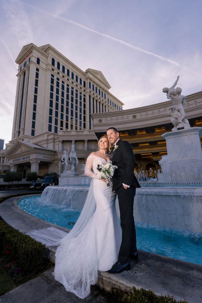 bride and groom portrait by fountain Caesars Palace Las Vegas wedding photographed by Zoltan Redl Nagy