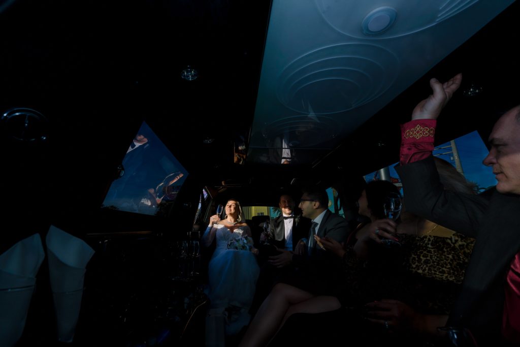 wedding limousine party inside Las Vegas with bride groom and guests night celebration photographed by Zoltan Redl Nagy