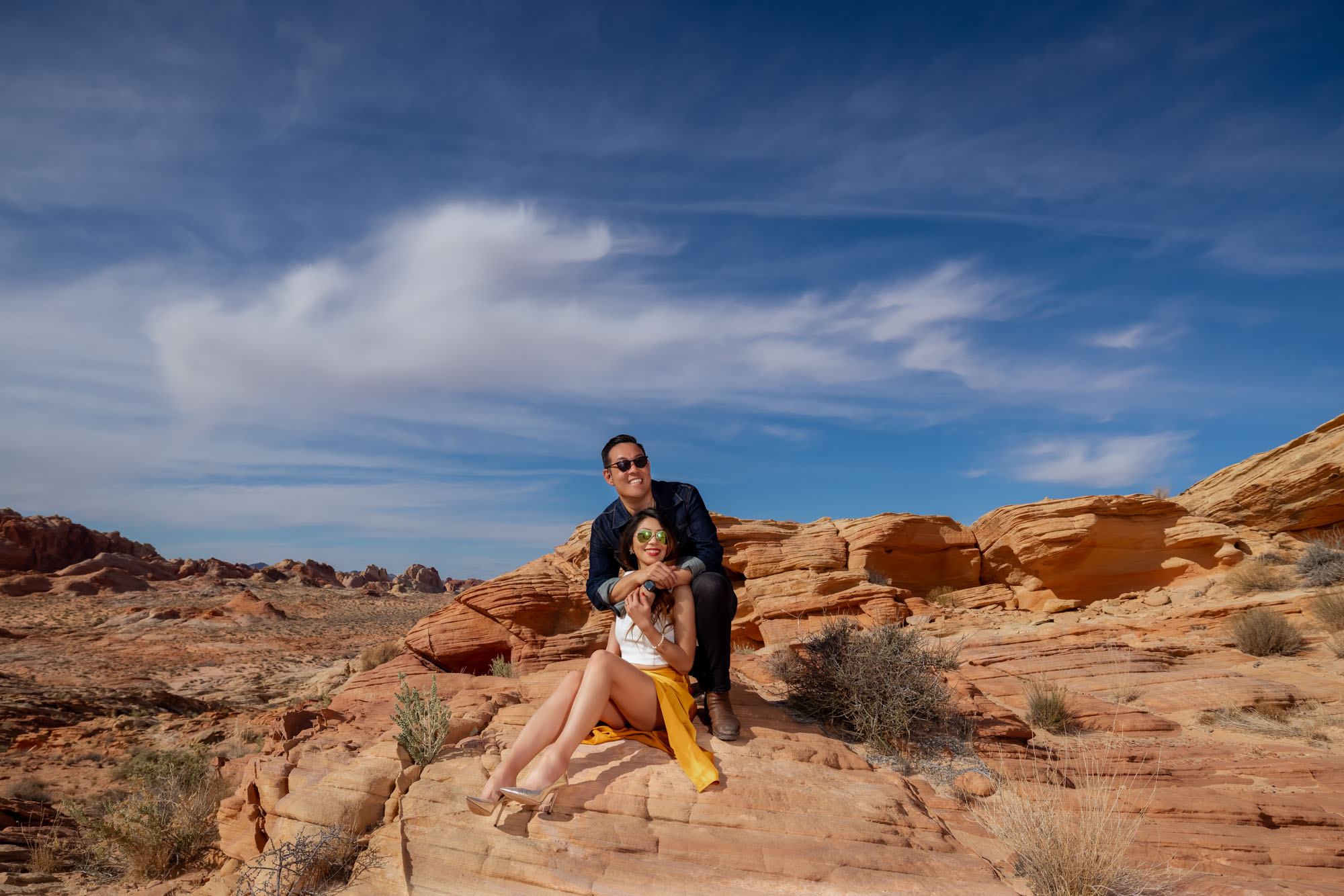 Valley of Fire elopement couple sitting on red rock formation Nevada desert photographed by Zoltan Redl Nagy