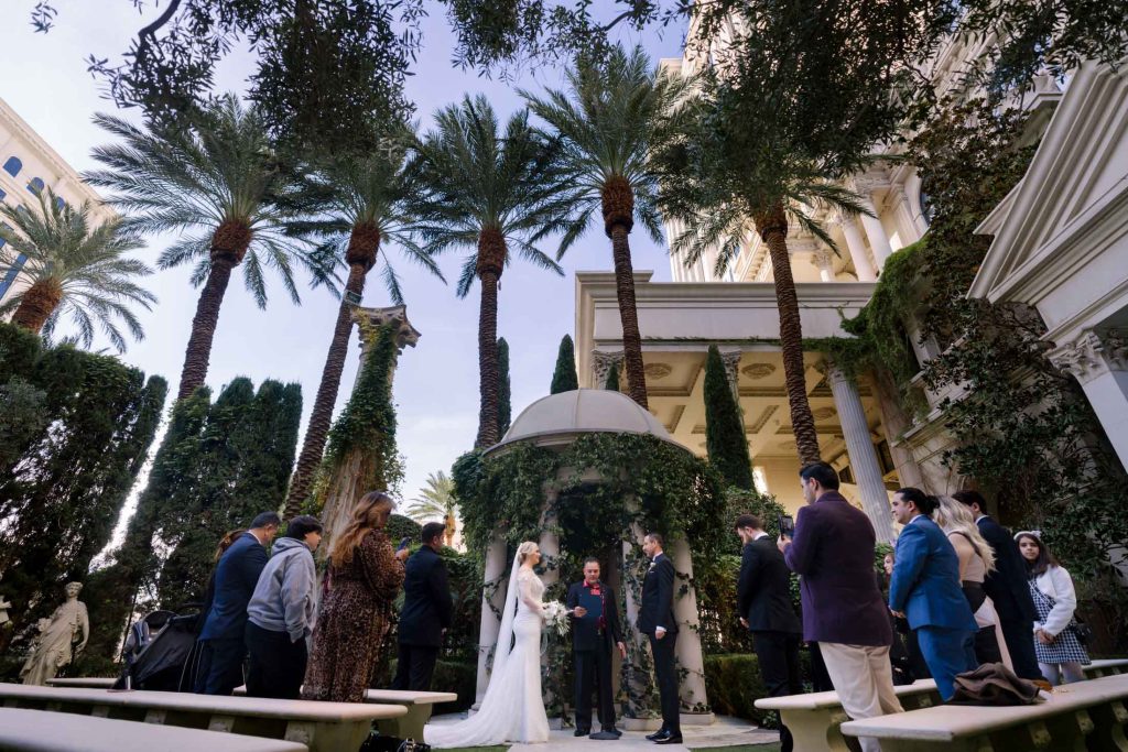 Las Vegas wedding ceremony at Caesars Palace Venus Garden with couple exchanging vows photographed by Zoltan Redl Nagy