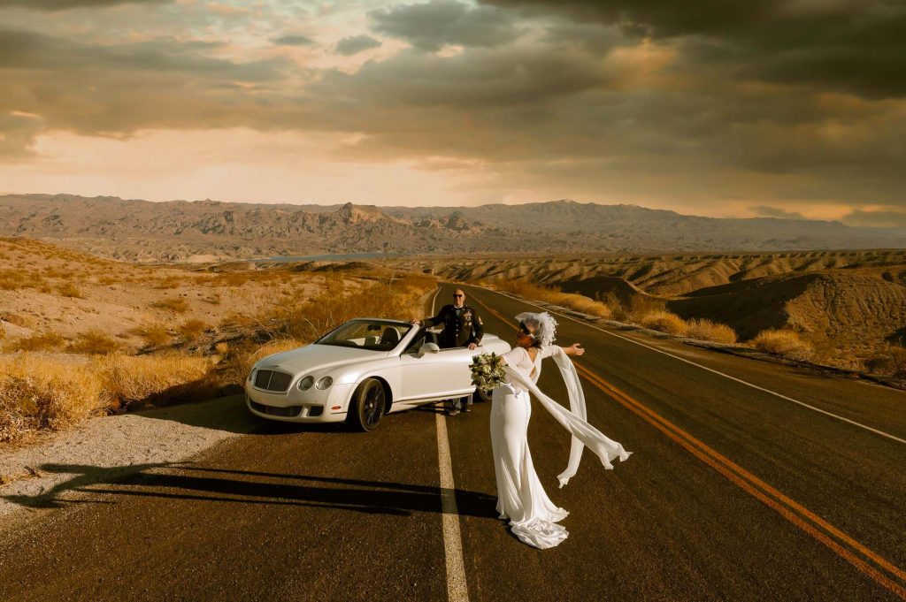 Luxury elopement couple with white convertible car on desert road near Colorado River Nevada Las Vegas