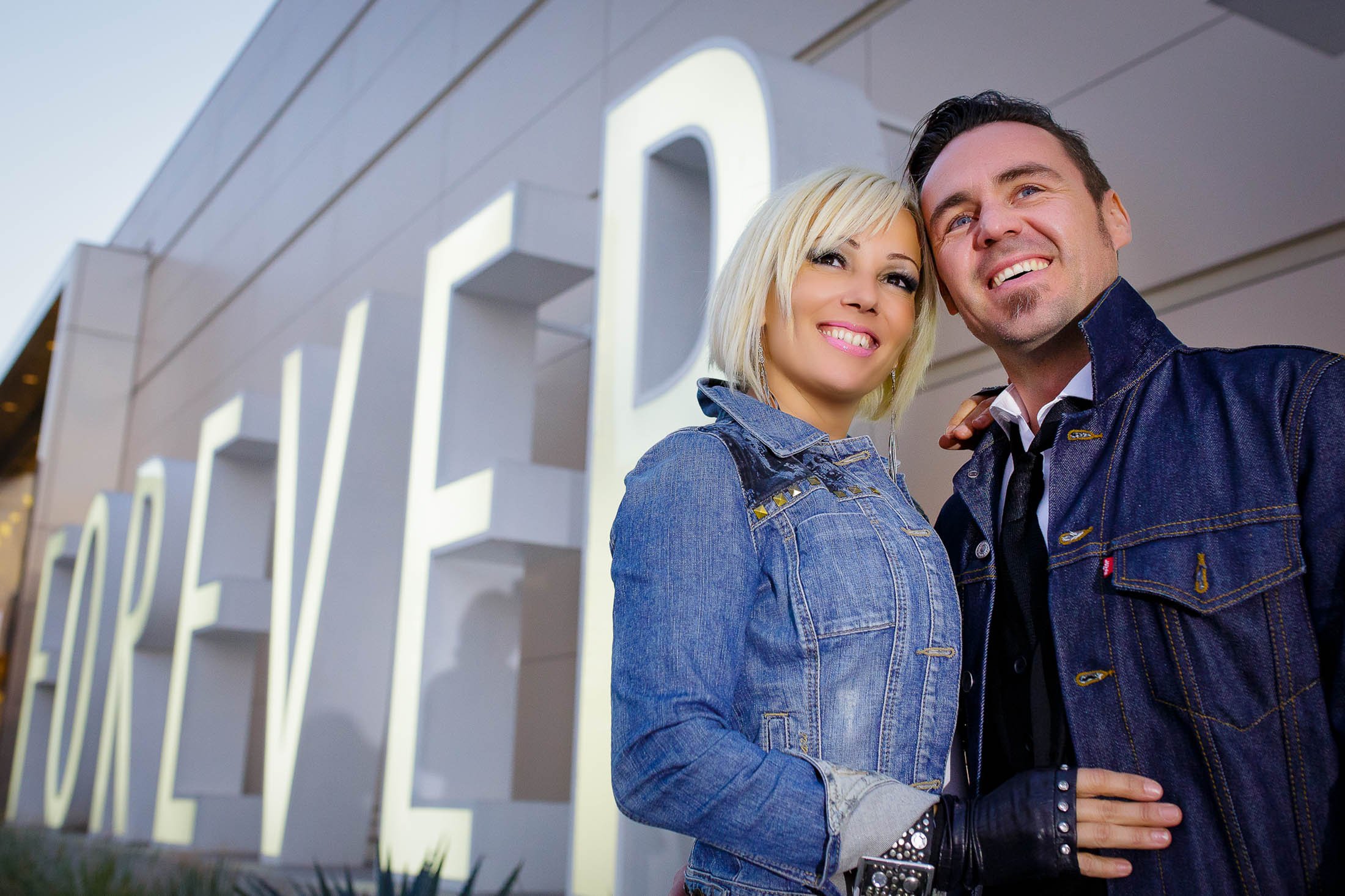 Engagement couple at Forever 21 sign Las Vegas portrait photographed by Zoltan Redl Nagy