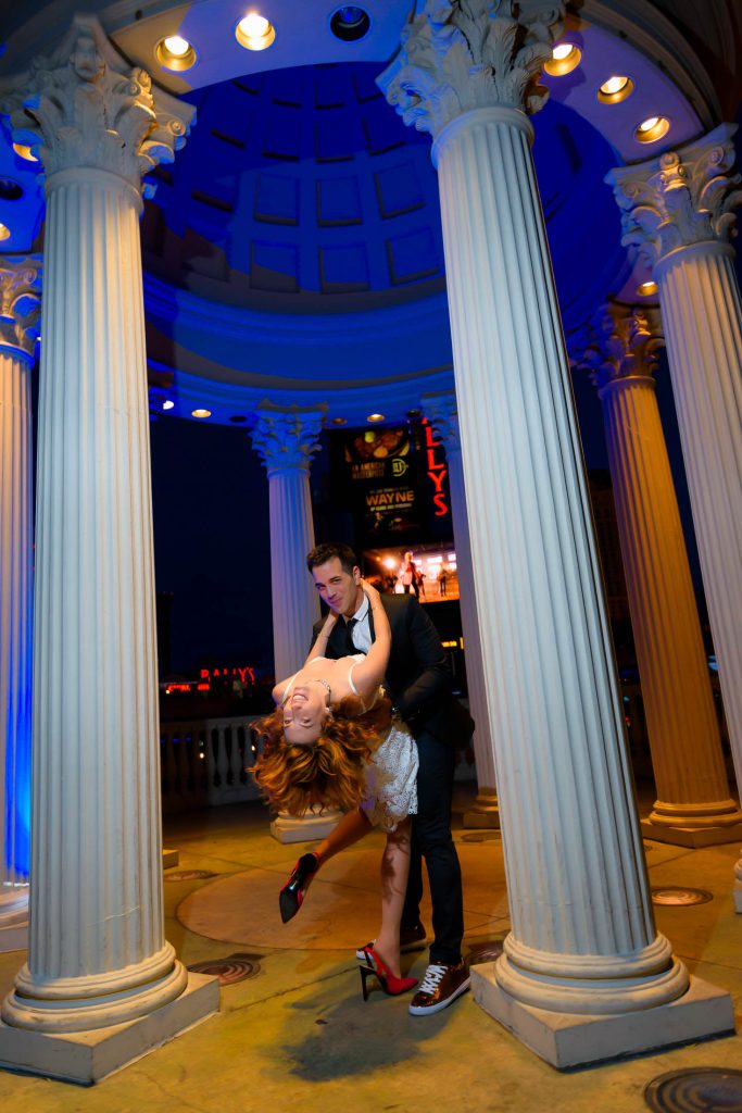 Las Vegas elopement dramatic dip kiss pose at Caesars Palace gazebo at night, photographed by Zoltan Redl-Nagy