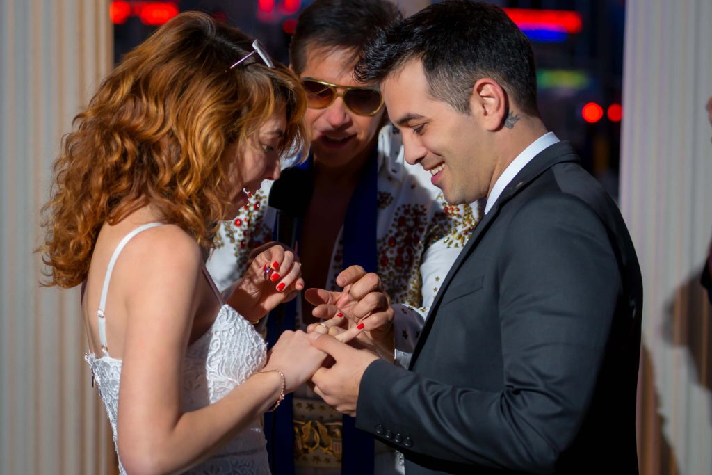 Las Vegas Elvis elopement ring exchange at Caesars Palace gazebo with bride and groom during vows ceremony, photographed by Zoltan Redl-Nagy