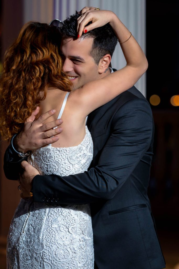 Romantic Las Vegas elopement couple embracing during Elvis wedding at Caesars Palace gazebo, intimate moment captured in soft evening light, photographed by Zoltan Redl-Nagy