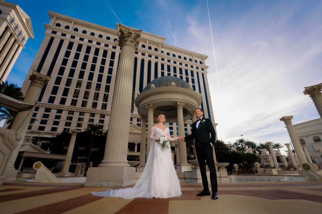 Luxury wedding couple portrait in front of Caesars Palace hotel in Las Vegas