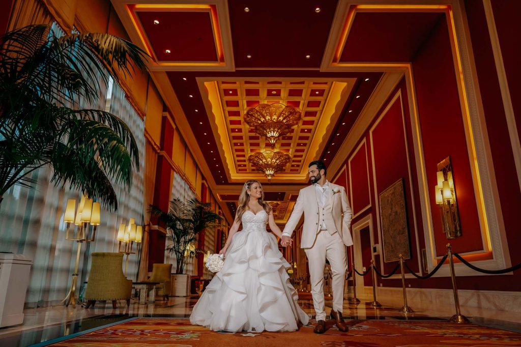 Luxury wedding couple walking inside the elegant Wynn Las Vegas resort hallway