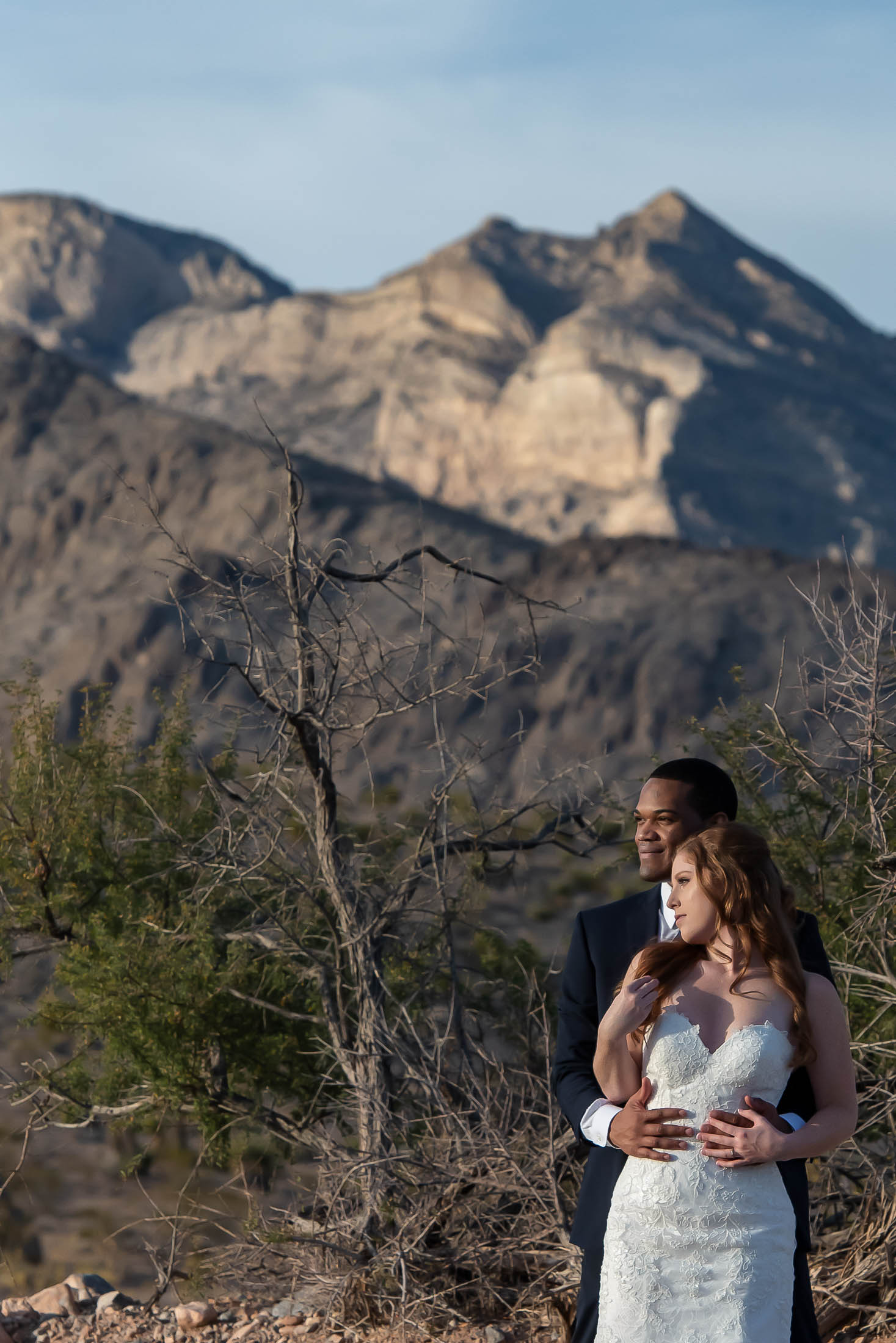 Red Rock Canyon elopement couple intimate embrace with mountains in background
