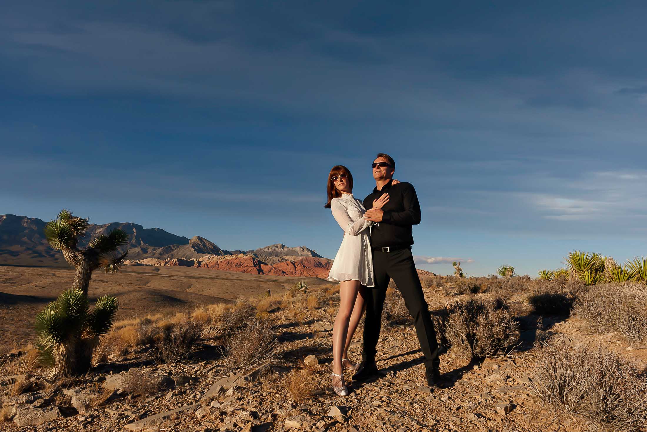 Red Rock Canyon elopement couple full body fashion pose in desert landscape with mountains