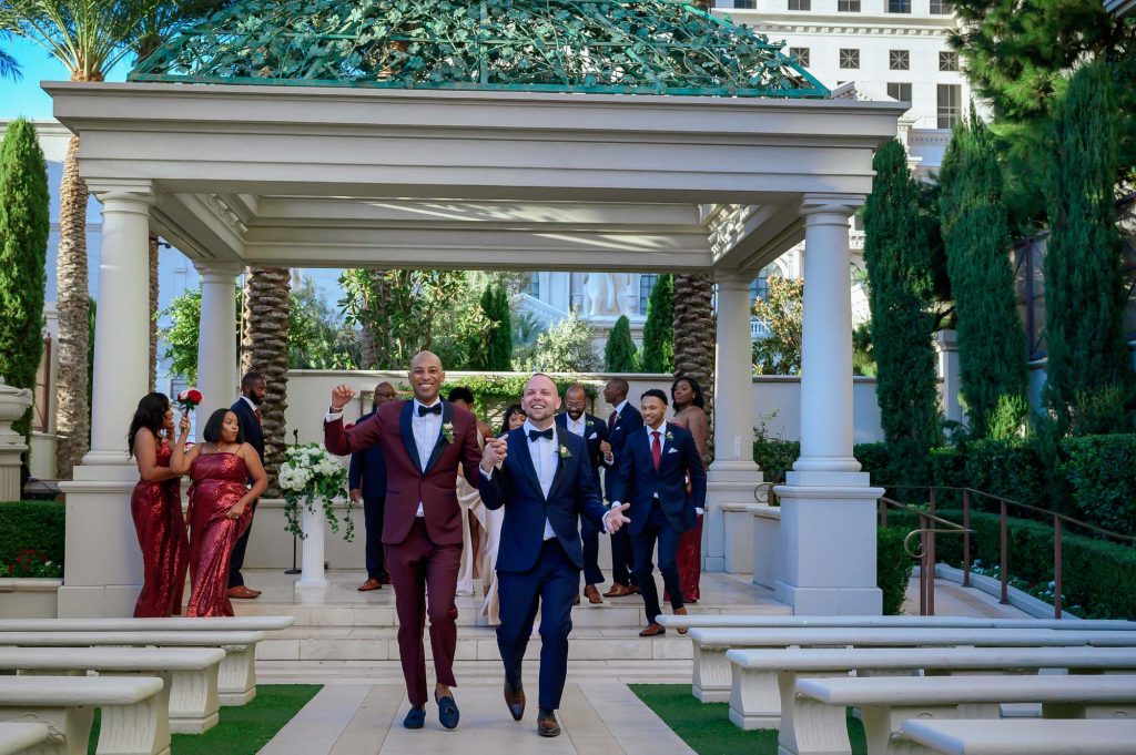 Same-sex wedding couple celebrating with guests at Juno Garden in Caesars Palace Las Vegas
