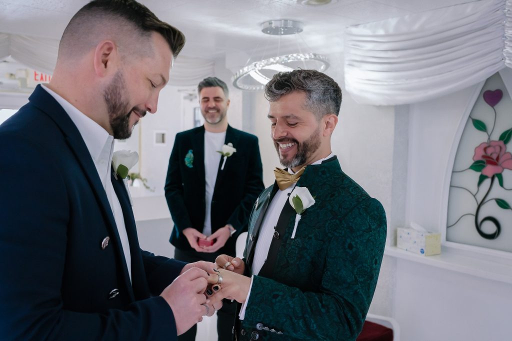 Same-sex elopement ring exchange ceremony at Little White Chapel Las Vegas photographed by Zoltan Redl Nagy