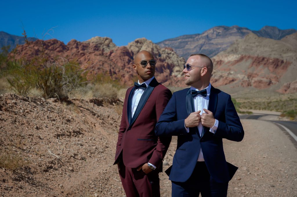 Same-sex wedding grooms posing at Red Rock Canyon near Las Vegas during desert wedding portrait session