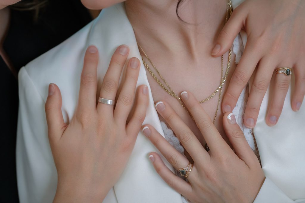 Same-sex elopement wedding rings detail of two brides hands photographed by Zoltan Redl Nagy