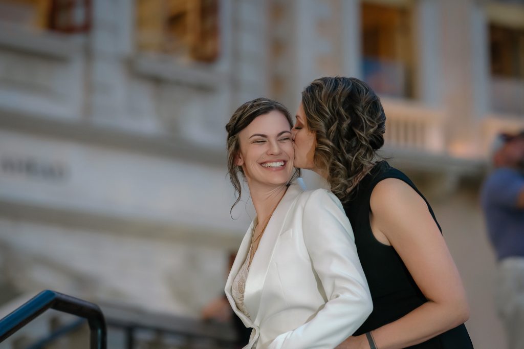 Same-sex elopement brides kissing at Venetian Las Vegas photographed by Zoltan Redl Nagy