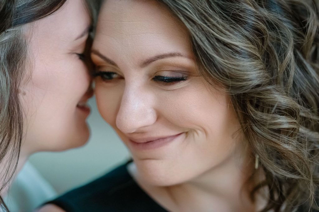 Same-sex elopement brides intimate close-up moment photographed by Zoltan Redl Nagy