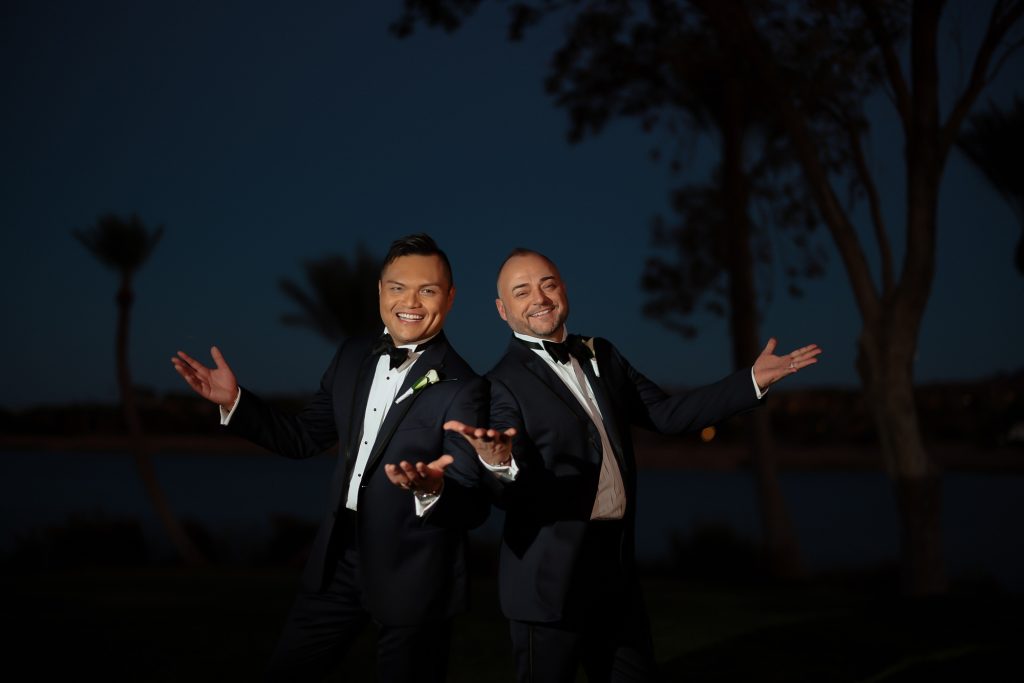 Happy gay wedding couple posing at night at The Westin Lake Las Vegas during their same-sex wedding celebration