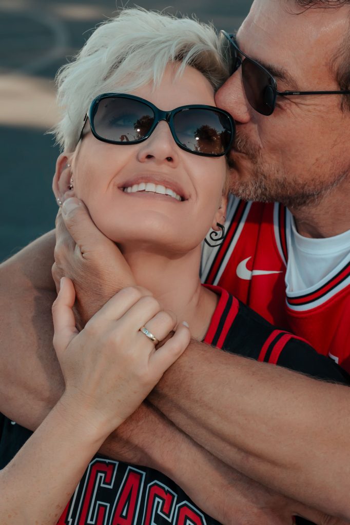 Intimate renewal elopement couple portrait with kiss and rings detail in Las Vegas Arts District, photographed by Zoltan Redl Nagy.