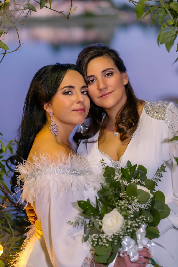 Same sex wedding brides portrait at Lake Las Vegas wedding venue with bouquet, photographed by Zoltan Redl Nagy.