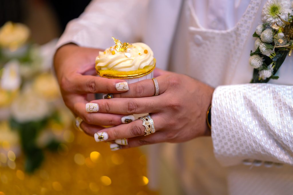 Same sex wedding cupcake detail with rings and hands in Las Vegas, photographed by Zoltan Redl Nagy.