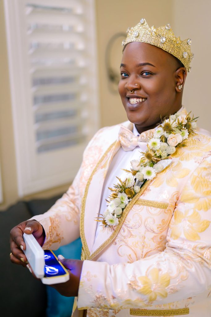 Same sex wedding groom holding gift box with jewelry during preparation in Las Vegas, photographed by Zoltan Redl Nagy.