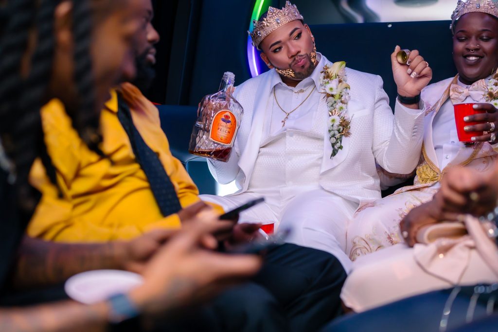 Same sex wedding couple celebrating in limo with drinks and friends in Las Vegas, photographed by Zoltan Redl Nagy.