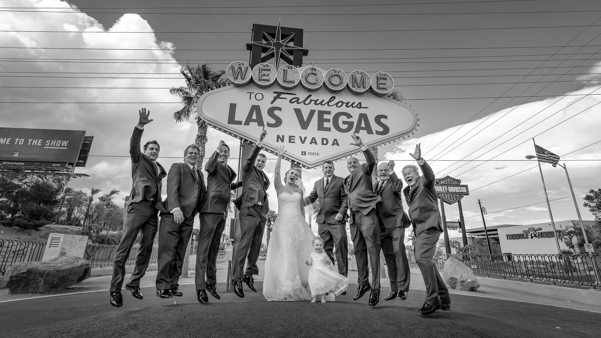 Las Vegas wedding group photo at Welcome to Fabulous Las Vegas sign black and white photographed by Zoltan Redl Nagy