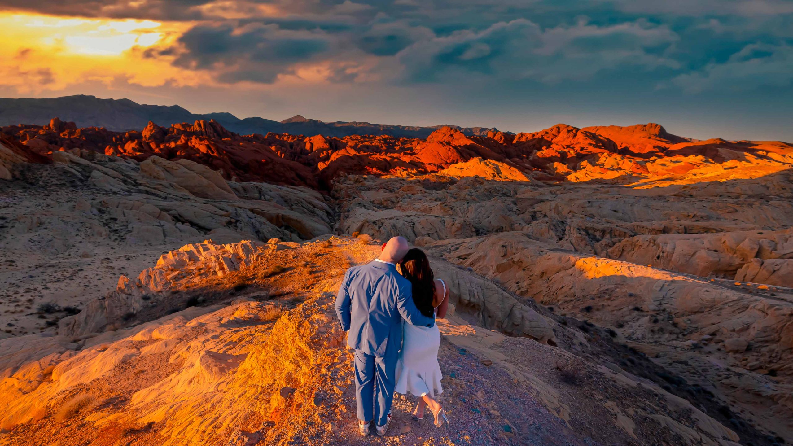 Romantic sunrise wedding portrait overlooking the colorful desert landscape at Valley of Fire State Park near Las Vegas