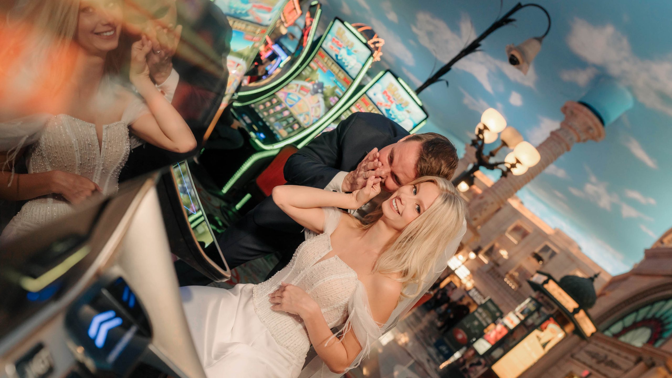 Bride and groom playing slot machines during a Paris Las Vegas Hotel elopement photo session