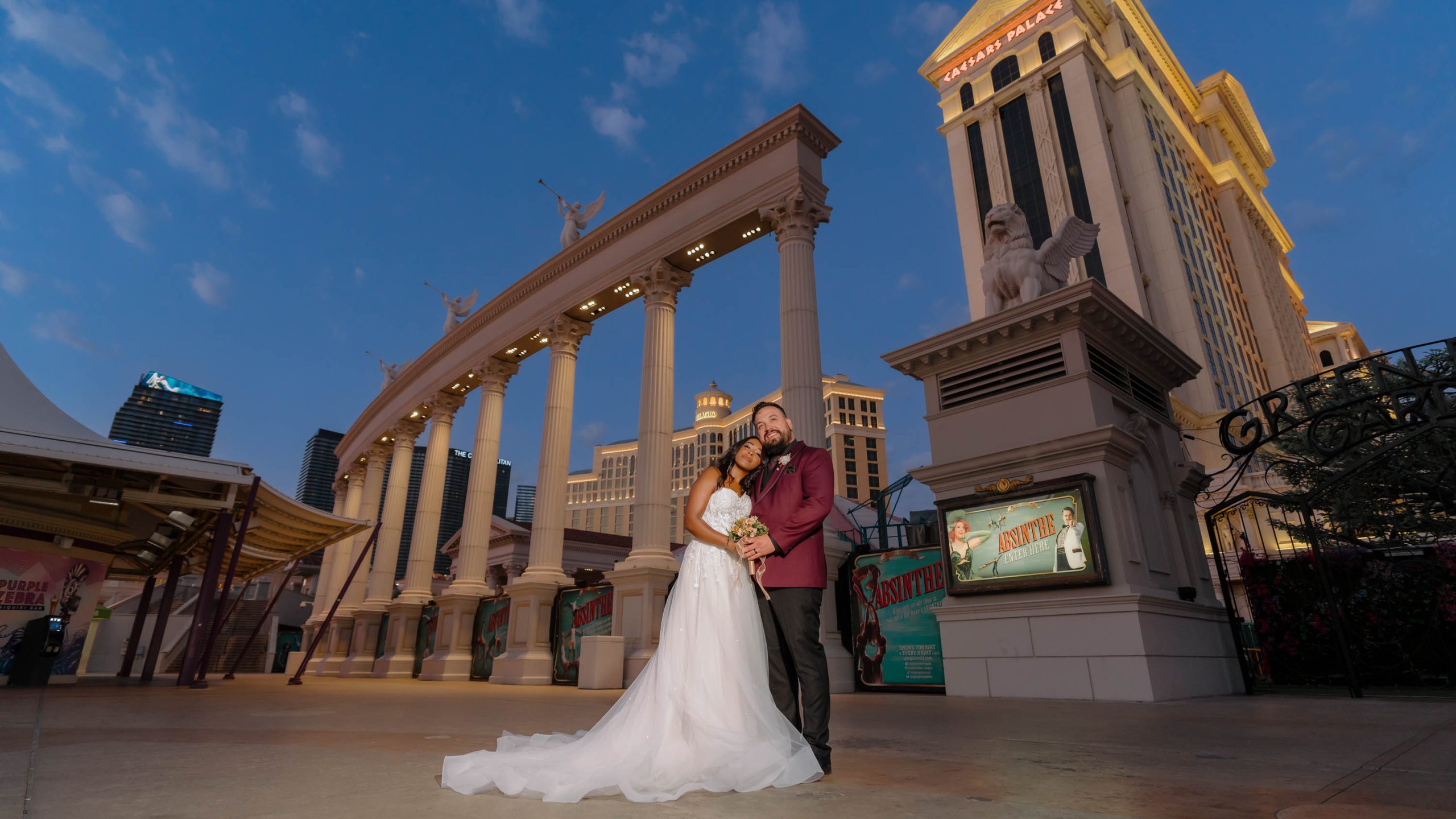 Bride and groom at Caesars Palace during early blue hour in Las Vegas