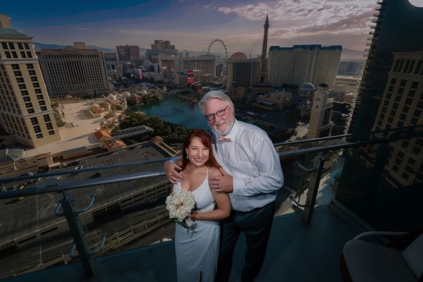 Las Vegas Strip elopement couple on Cosmopolitan hotel balcony overlooking skyline photographed by Zoltan Redl Nagy
