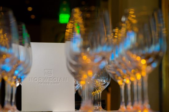 Las Vegas corporate awards dinner setup with branded Norweigan Cruise Line menu and elegant glassware, photographed by Zoltan Redl-Nagy