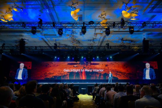 Las Vegas conference keynote presentation with large LED screen and audience at corporate event, photographed by Zoltan Redl-Nagy