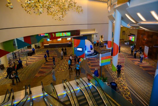 Las Vegas convention center lobby networking scene with attendees at corporate conference, photographed by Zoltan Redl-Nagy