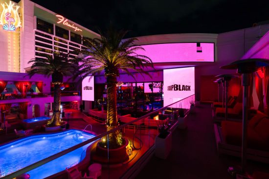 Las Vegas corporate rooftop pool event at Drai’s Beachclub at The Cromwell with vibrant lighting and brand screens, photographed by Zoltan Redl-Nagy