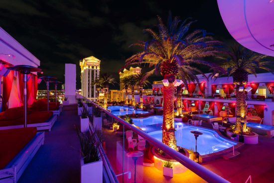 Las Vegas luxury rooftop pool party at Drai’s Beachclub at The Cromwell with vibrant night lighting and city views, photographed by Zoltan Redl-Nagy
