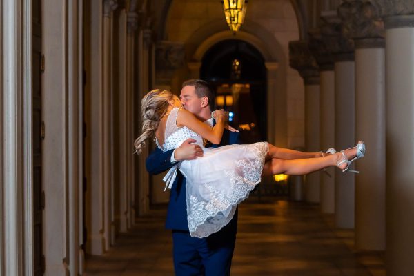 Las Vegas Strip elopement romantic carry moment at The Venetian at night with elegant arches, photographed by Zoltan Redl-Nagy