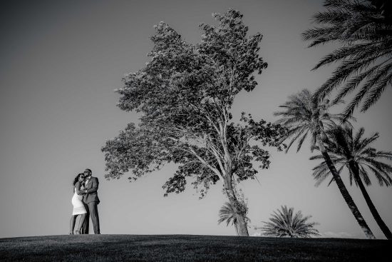 Engagement couple standing together under trees at Westin Lake Las Vegas black and white photographed by Zoltan Redl Nagy