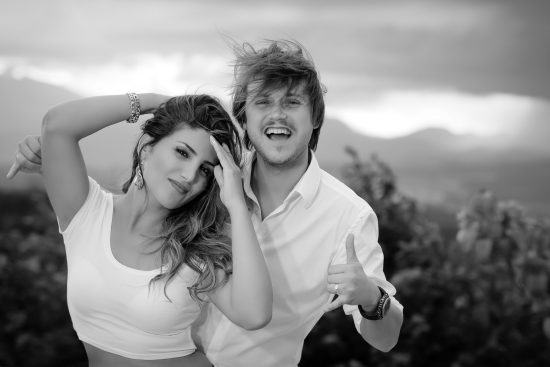 Engagement couple laughing in the wind candid moment in Las Vegas desert mountains photographed by Zoltan Redl Nagy