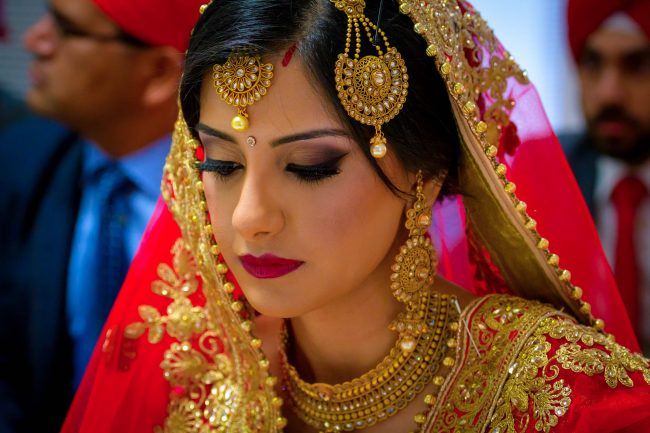 indian wedding bride close up portrait with traditional gold jewelry