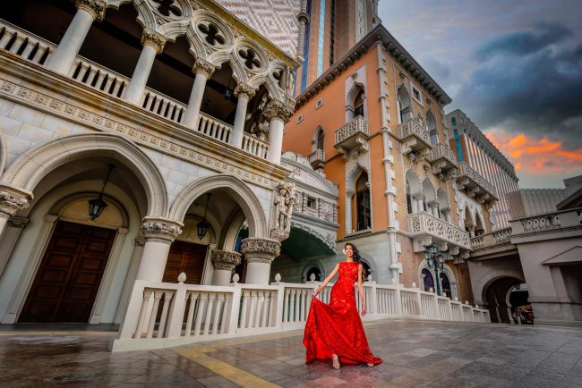elegant woman in red dress portrait at The Venetian Las Vegas architecture