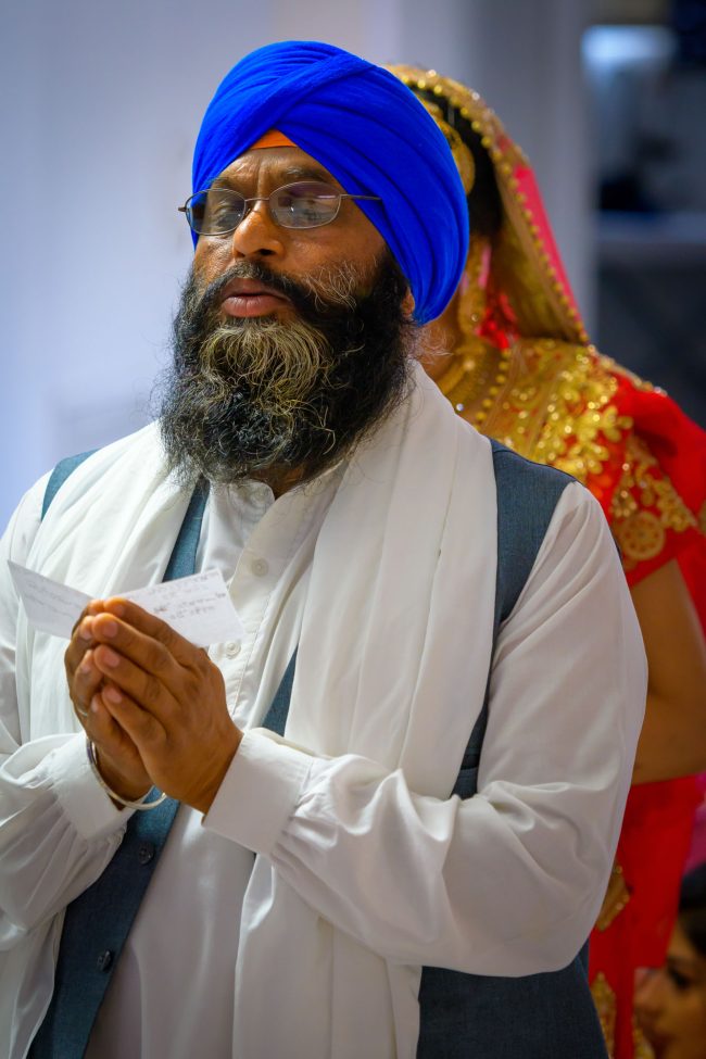 sikh priest leading indian wedding ceremony traditional sikh wedding photo by zoltan redl-nagy
