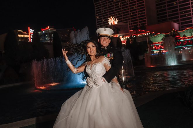 Wedding couple at Caesars Palace fountain entrance at night Las Vegas