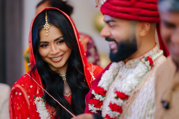 Indian wedding bride and groom traditional ceremony portrait smiling couple